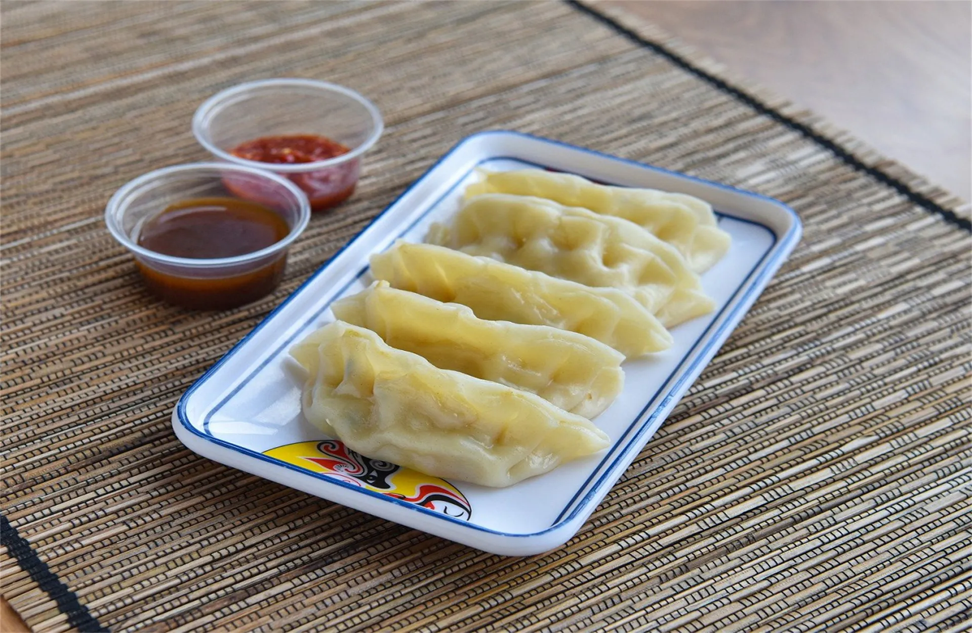 Steamed dumplings served with two dipping sauces at Happy Oriental Cafe, a Chinese Restaurant in Longview